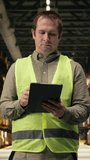 Vertical Video Worker checking shipment labels in modern warehouse facility. Manual labor combined with technology supports storage organization, e-commerce delivery and merchandise distribution. - Powered by Shutterstock - Get 15% off with code: PIKWIZARD15