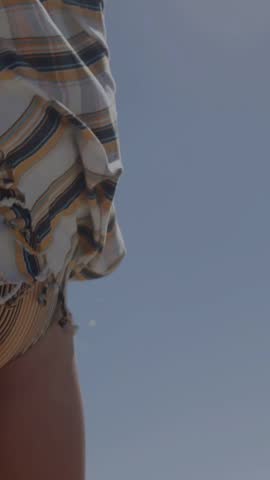Vertical video: Girl lifting head and opening mouth as data bars rising, visualizing trends. Minor, poolside, outdoor, sunlit, stock, vibrant, vertical video