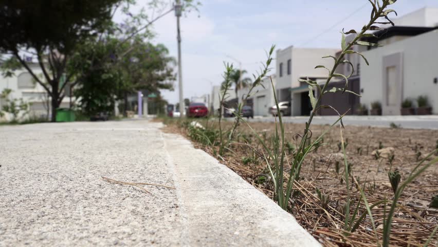 A slow motion closeup of a radio control car drifting on the pavement and dirt of a park