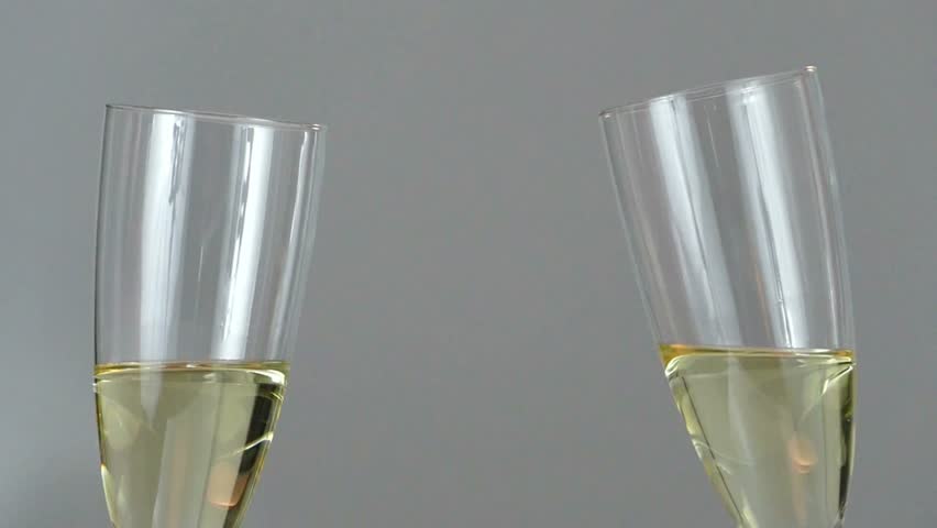 Lovely couple clinking glasses celebrating holding glasses with champagne, close-up hands New Year