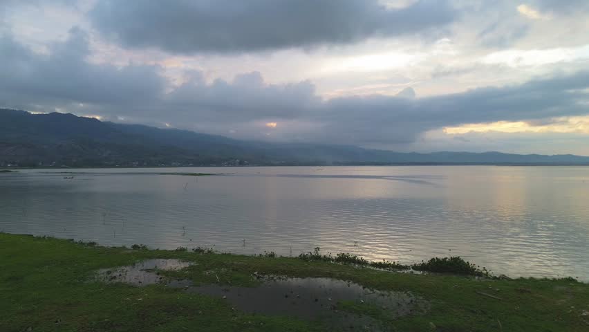 Calm Lake at Dusk with Mountain Range