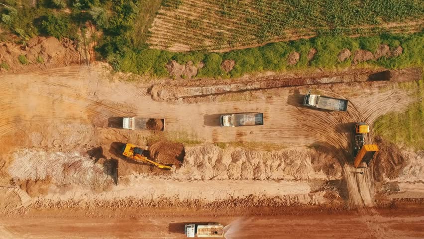top view of Excavator Digging Up Ground mining open pit aerial for content industrial presentation ads.