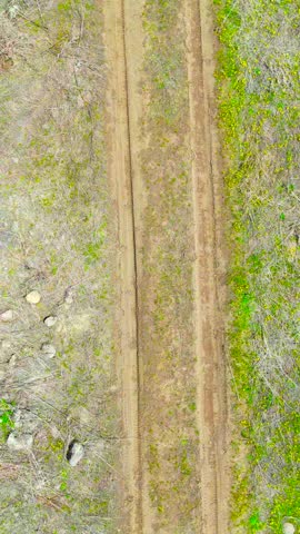Top View of Rural Dirt Road Crossing Dry Grassland Terrain