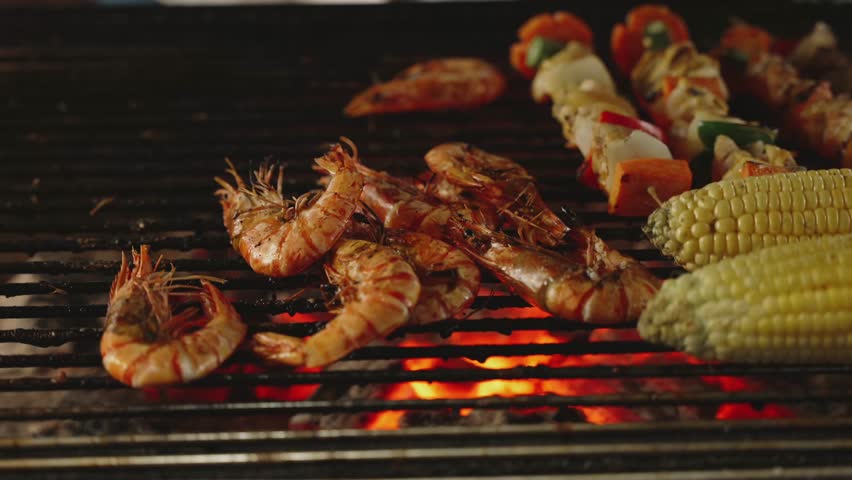 Close up of Street Food BBQ Grill with Fresh Shrimp and Corn at Night Market