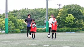 A youth soccer team and their coach practicing juggling the ball. - Powered by Shutterstock - Get 15% off with code: PIKWIZARD15