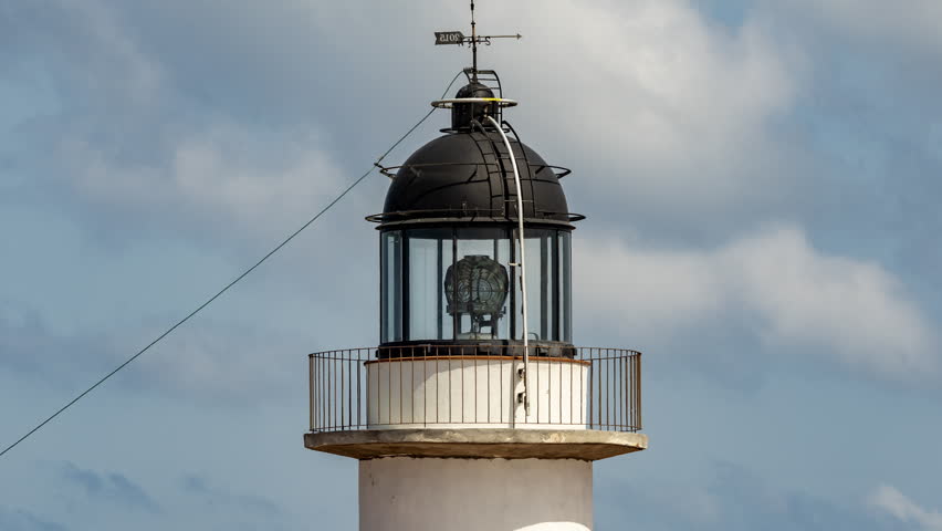 the light house in cap de creus in spain with passing clouds