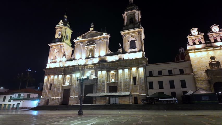 Stunning night shot showing the majestic architecture of the main cathedral and the wide colonial square in Bogota.