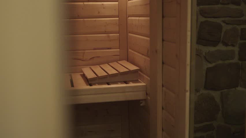 Traditional finnish wooden sauna interior with benches for steam bath therapy and relaxation