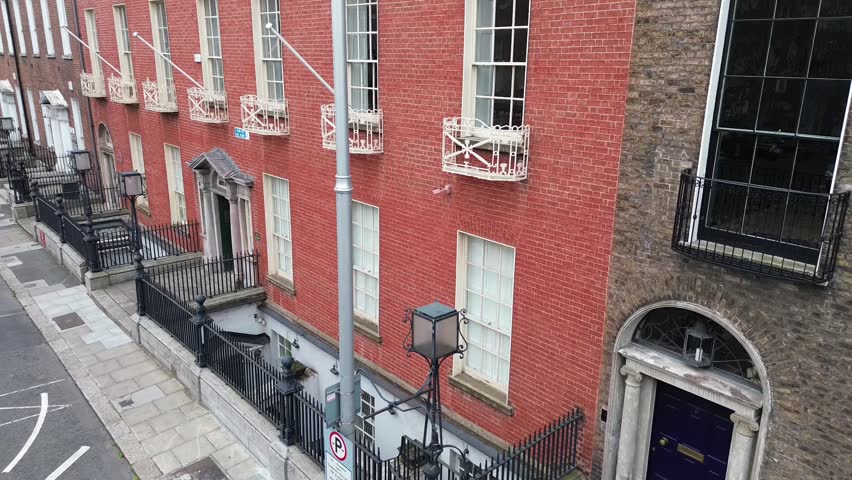 Elegant ornamental street lamp on Ely Place in Dublin, Ireland, captured with smooth tilt up and tilt down camera movement showcasing historic urban architecture and classic city details.