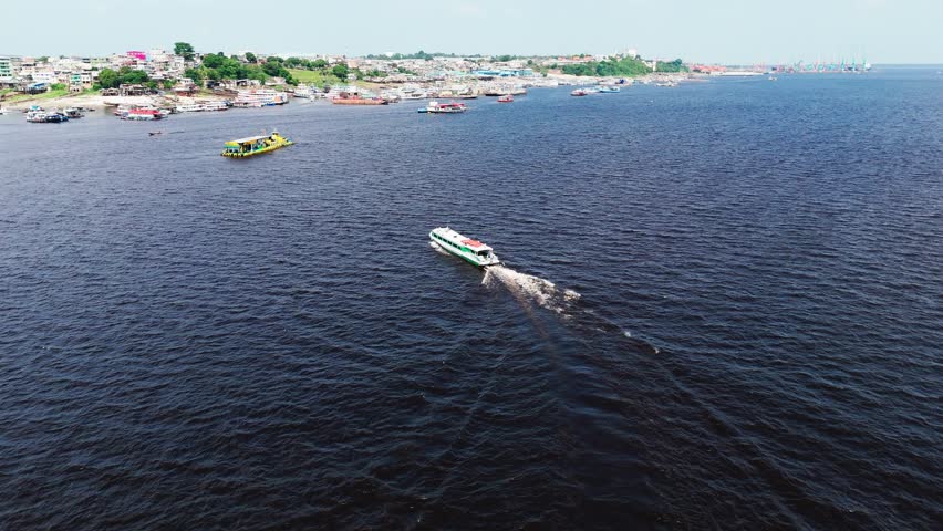 Cinematic Aerial view of Passenger Vessel heading towards Manaus City Port Terminal