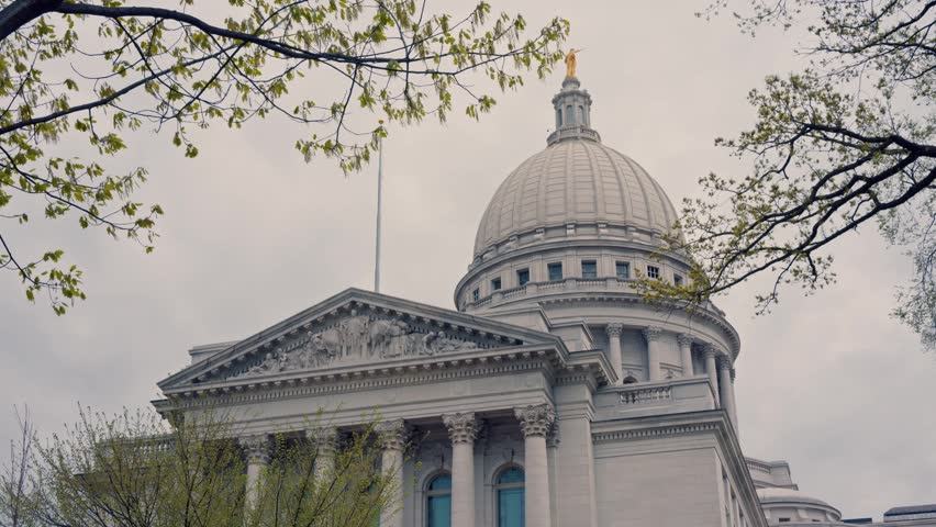 Cinematic gimbal dolly right shot of Wisconsin State Capitol building exterior with smooth stabilized horizontal camera movement.