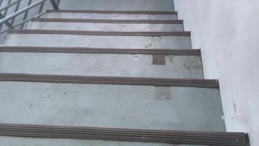 High angle view of concrete stairs with metal handrails in an office building.