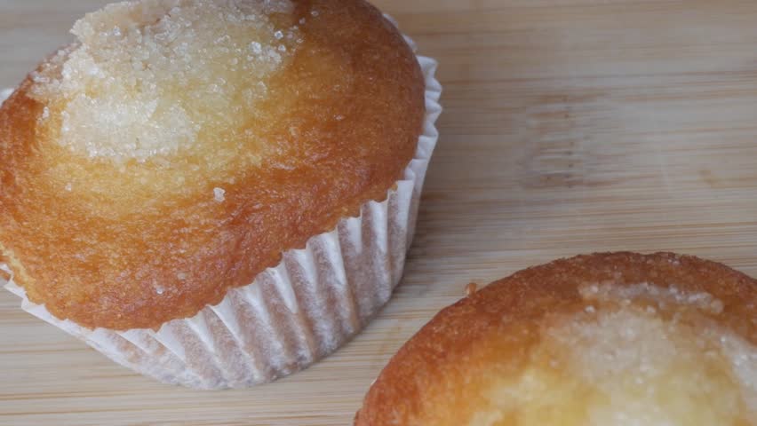Close-up of fresh muffins on a wooden board, simple and inviting