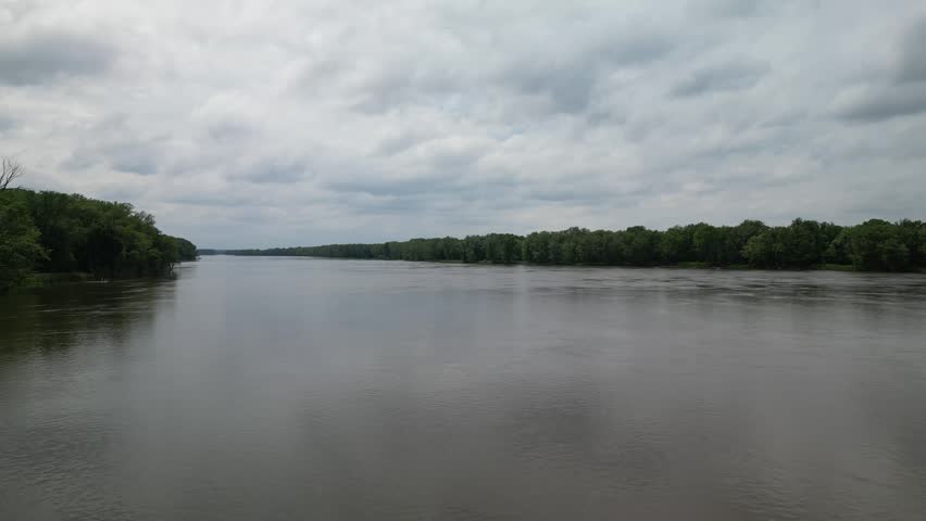 In the middle of the Mississippi River between Southern Illinois and Iowa flying up shows the length and width of this important river for transportation.  4k, drone, flying