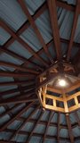 Unique symmetrical wooden ceiling structure of an octagon gazebo with a central light bulb - Powered by Shutterstock - Get 15% off with code: PIKWIZARD15