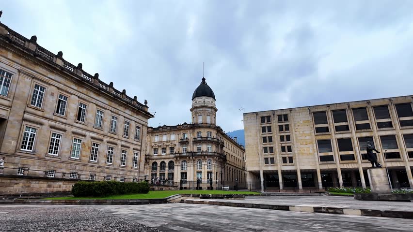 Daytime view of the impressive neoclassical building of the Colombian Congress across the historic main square.