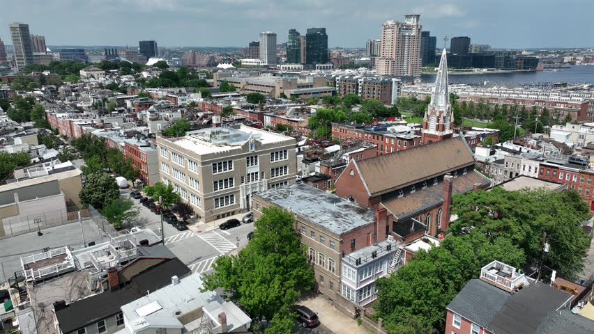 Riverside, Maryland, USA - June 9, 2025: A historic church stands alongside row houses in the beautiful Riverside neighborhood.