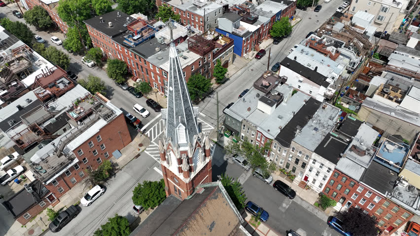 Riverside, Maryland, USA - June 9, 2025: A historic church stands alongside row houses in the beautiful Riverside neighborhood.