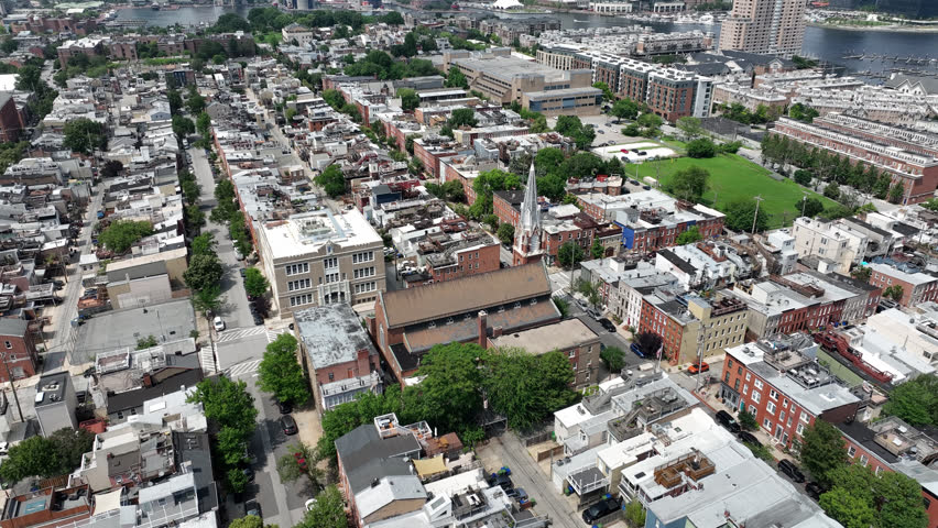 Riverside, Maryland, USA - June 9, 2025: A historic church stands alongside row houses in the beautiful Riverside neighborhood.
