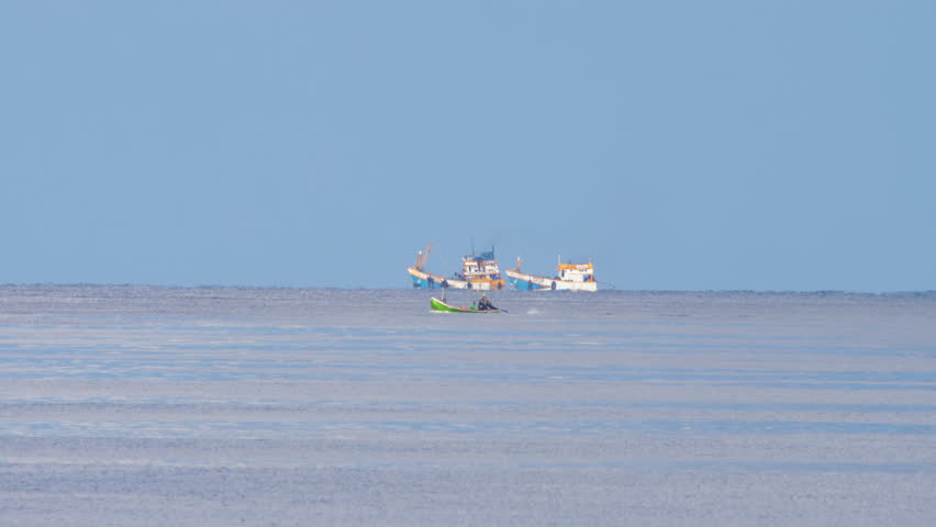 Traditional fishing boats at work in calm waters of Andaman Sea
