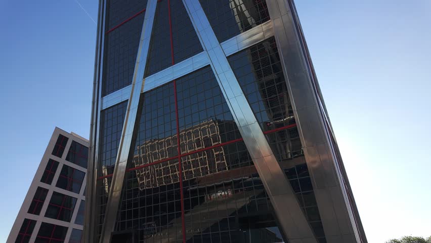 Reflections of the capital Madrid in glass and steel buildings where offices and businesses are located, Spain.