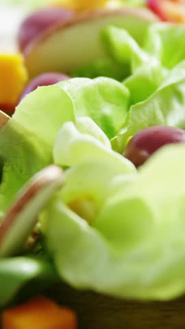 Vertical video: Cursor clicking subscribe ribbon badges sliding over salad driving marketing growth. Greens, cucumber, olives, mushrooms, peppers, colorful, vertical video