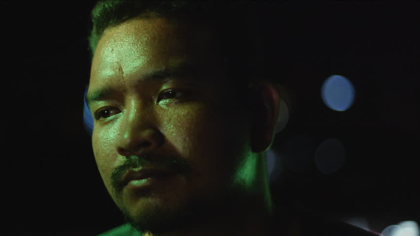 Filipino person singing with passion at night