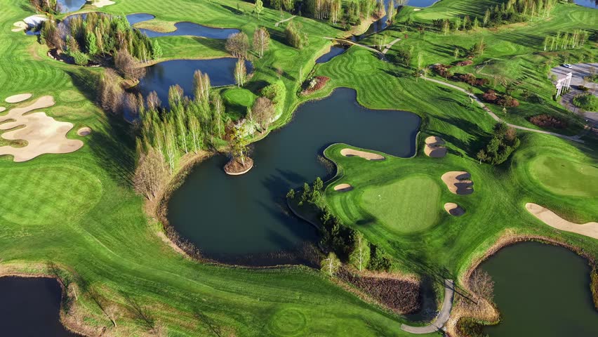 Golf course landscape with calm lakes and water features