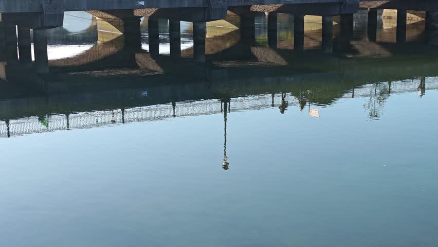Reflections of pilgrims walking across the romanes que Bridge of A Ramallosa on the camino de Santiago, Nigran, Pontevedra, Spain.