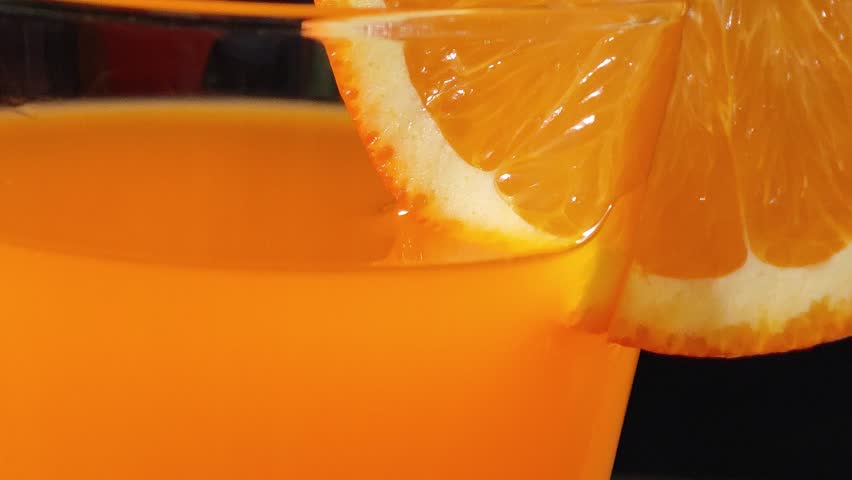 Sliced ​​oranges and orange juice in a glass.	