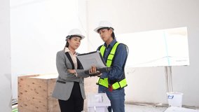Asian engineer use notebook computer and female architect reviewing architectural plans and examining a building model at a renovation or construction site - Powered by Shutterstock - Get 15% off with code: PIKWIZARD15