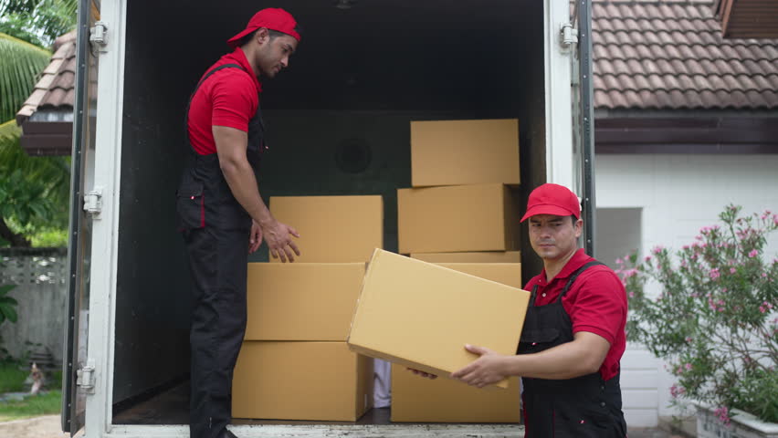 Delivery men move items to a house. Blue collar worker, occupation.