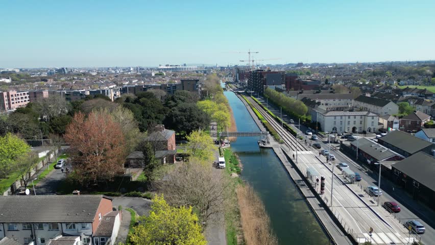 Scenic video footage of the Grand Canal in Inchicore, Dublin, Ireland on a bright sunny day. Calm canal waters, greenery and urban surroundings captured in natural daylight with peaceful atmosphere and cinematic movement.