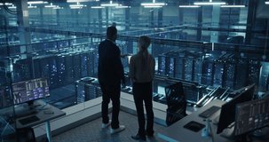Male Specialist and Female Analyst Activate Information Flow in a Data Center, Using Computer Systems and Tablet to Monitor AI Computing Processes, Software and Data Analysis. - Powered by Shutterstock - Get 15% off with code: PIKWIZARD15