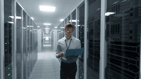 It Specialist Monitors Server Racks With a Laptop Inside a Modern Data Center, Managing Cloud Infrastructure, System Performance, Cybersecurity, AI Workloads, and Digital Operations. - Powered by Shutterstock - Get 15% off with code: PIKWIZARD15