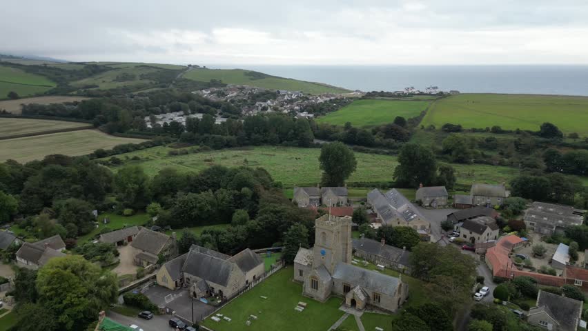 aerial Establishing Shot of Burton Bradstock Village with St Mary