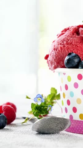 refreshing berry sorbet ice cream with fresh blueberries and raspberries in polka dot cup