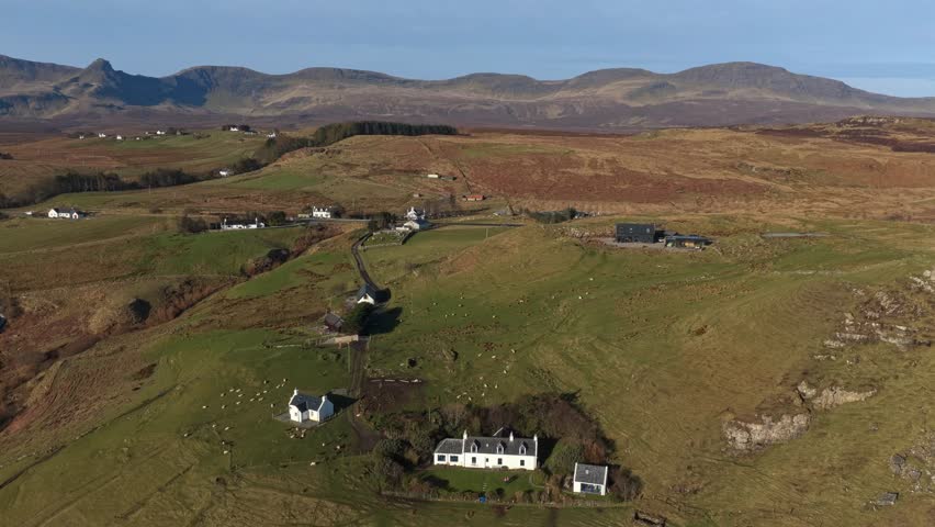 Expansive aerial footage showcasing the stunning rural landscape of brothers point on the isle of skye, with scattered houses and mountains