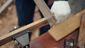 Confident carpenter man sawing wooden board with hand saw inside workshop. Wood processing inside timber workshop. DIY woodworking, handmade furniture, home improvement and craftsmanship concept.
 - Powered by Shutterstock - Get 15% off with code: PIKWIZARD15