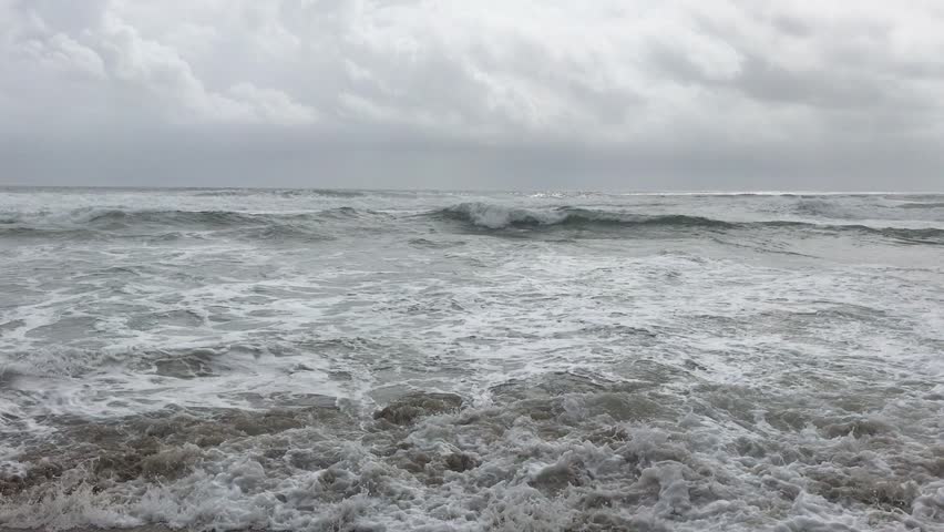 Strong ocean waves reaching the sandy beach of Varkala, India.