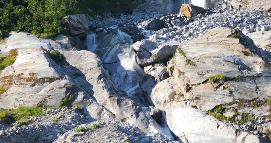 Waterfall in a sunny summer day at Endicott Arm fjord, Alaska.