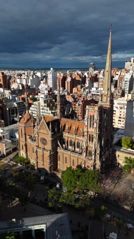 Aerial perspective of the sagrado corazón de jesús church, also known as los capuchinos, against a dramatic cloudy sky in cordoba, argentina