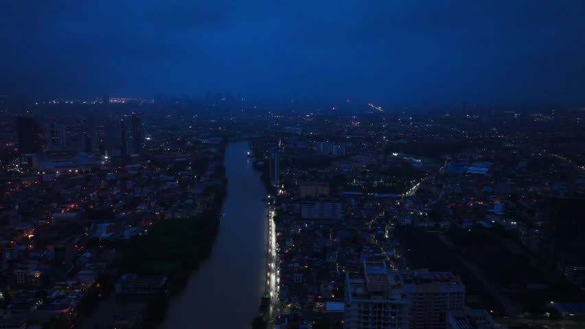 Drone slowly slides left, Makati City Metro Manila Philippines at night skyline