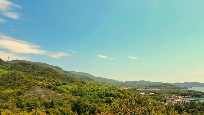 Scenic Coastal Landscape with Lush Green Hills and Blue Sea