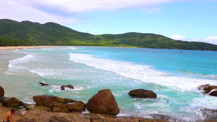 Amazing Praia de Lopes Mendes beach on the big tropical island Ilha Grande panorama with rocks waves and turquoise blue water in Angra dos Reis Rio de Janeiro Brazil.