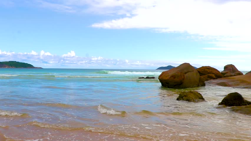 Amazing Praia de Lopes Mendes beach on the big tropical island Ilha Grande panorama with rocks waves and turquoise blue water in Angra dos Reis Rio de Janeiro Brazil.