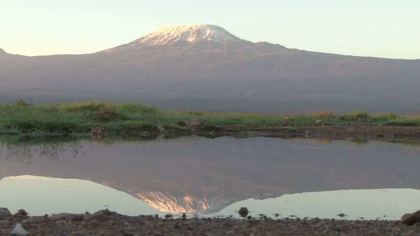reflection of kilimanjaro in a pond of water