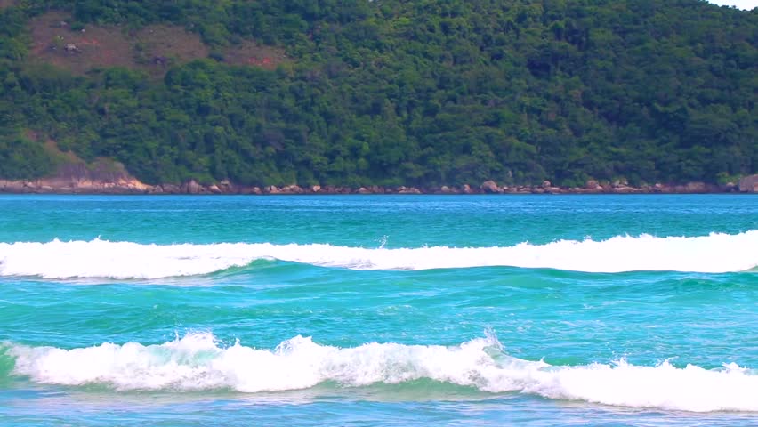 Strong waves at amazing Praia de Lopes Mendes beach on the big tropical island Ilha Grande seascape panorama ocean turquoise water blue sky in Angra dos Reis Rio de Janeiro Brazil.