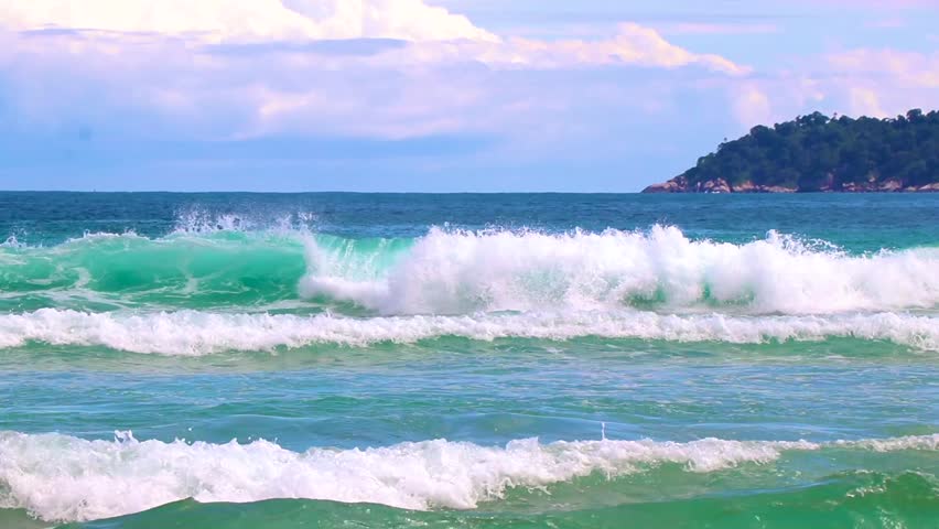 Strong waves at amazing Praia de Lopes Mendes beach on the big tropical island Ilha Grande seascape panorama ocean turquoise water blue sky in Angra dos Reis Rio de Janeiro Brazil.