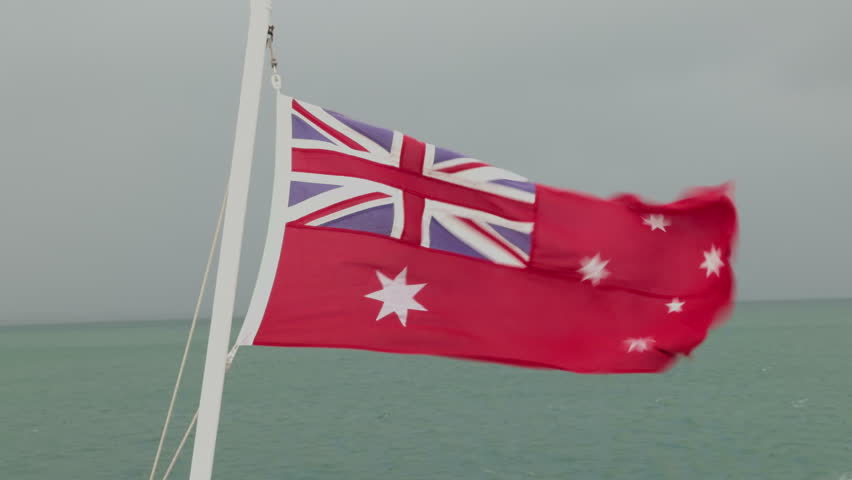 Australian Red Ensign Flag Blowing in Strong Wind on Moving Ferry